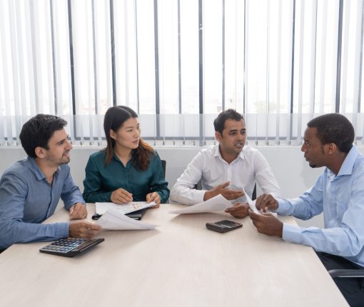 Mix raced business partners meeting in conference room Mix raced business partners meeting in conference room. Serious Indian team member speaking and gesturing emotionally, three colleagues listening to him. Negotiation and teamwork concept